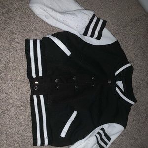 DeliA’s black and white varsity jacket.